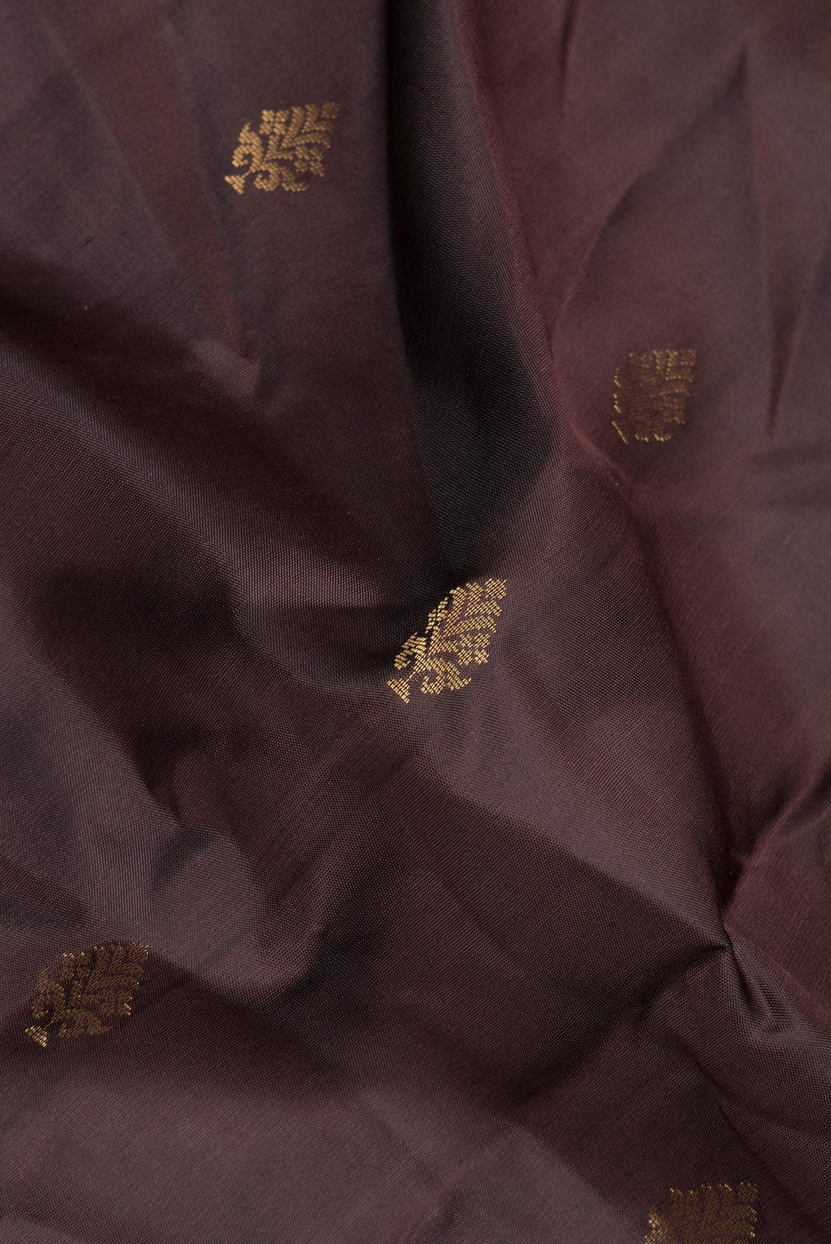 Close up of Pure Silk Coffee Brown Soft Saree with Zari Butta on the body and Zari Border.  displaying folds