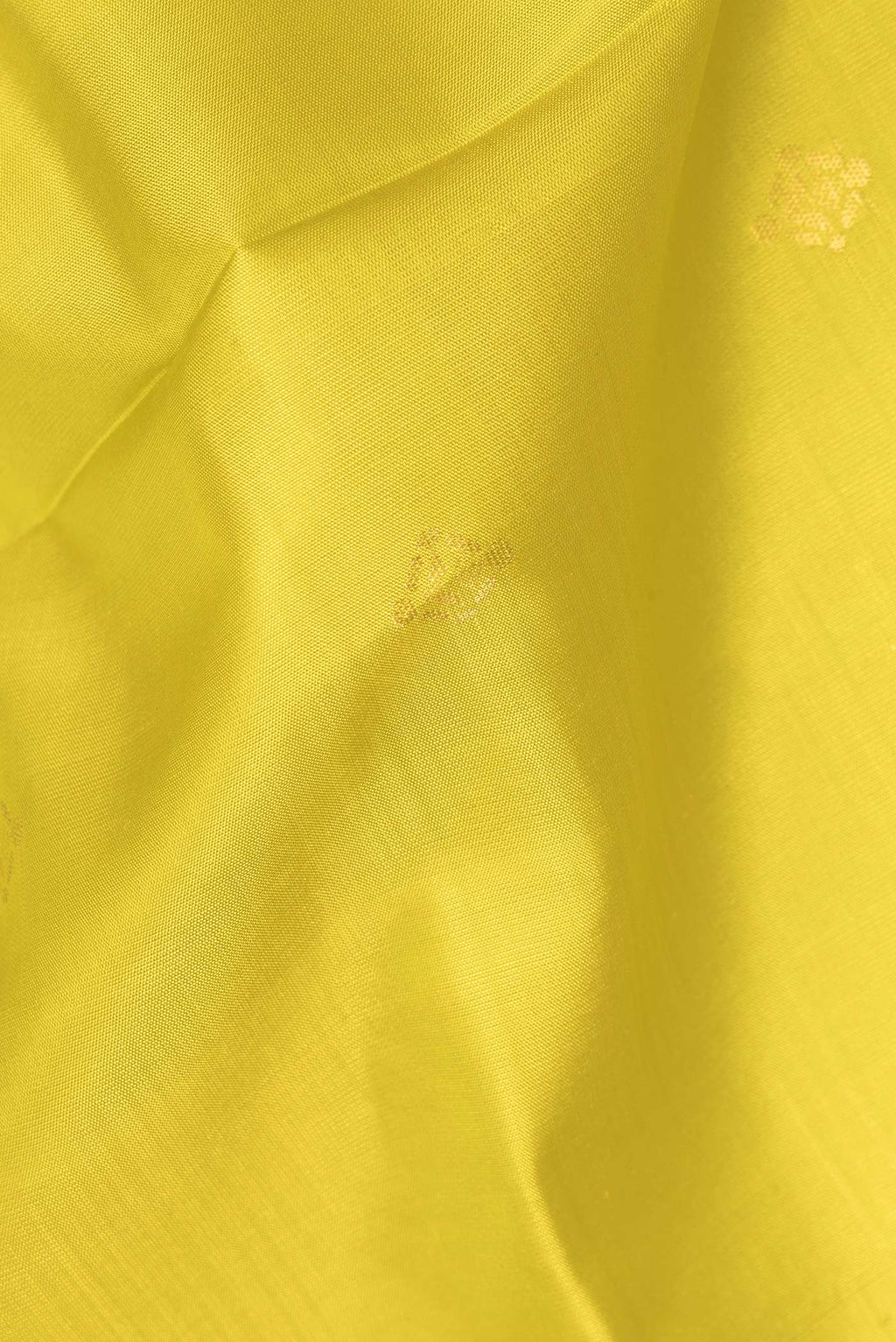 Close up of Pure Silk Yellow Soft Saree with Zari Butta on the body and Zari Border.  displaying folds