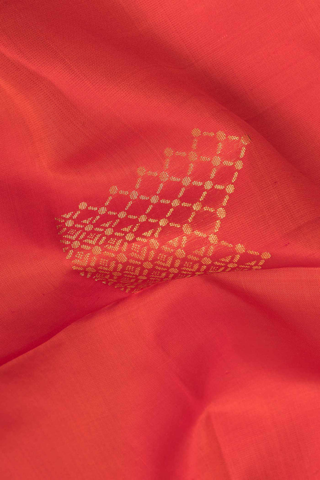 Close up of Pure Silk Orange Dual Tone Soft Saree with Zari Butta on the body and Zari Border.  displaying folds