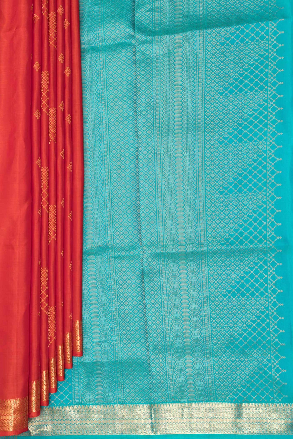 Pleats and pallu of Pure Silk Orange Dual Tone Soft Saree with Zari Butta on the body and Zari Border. 
