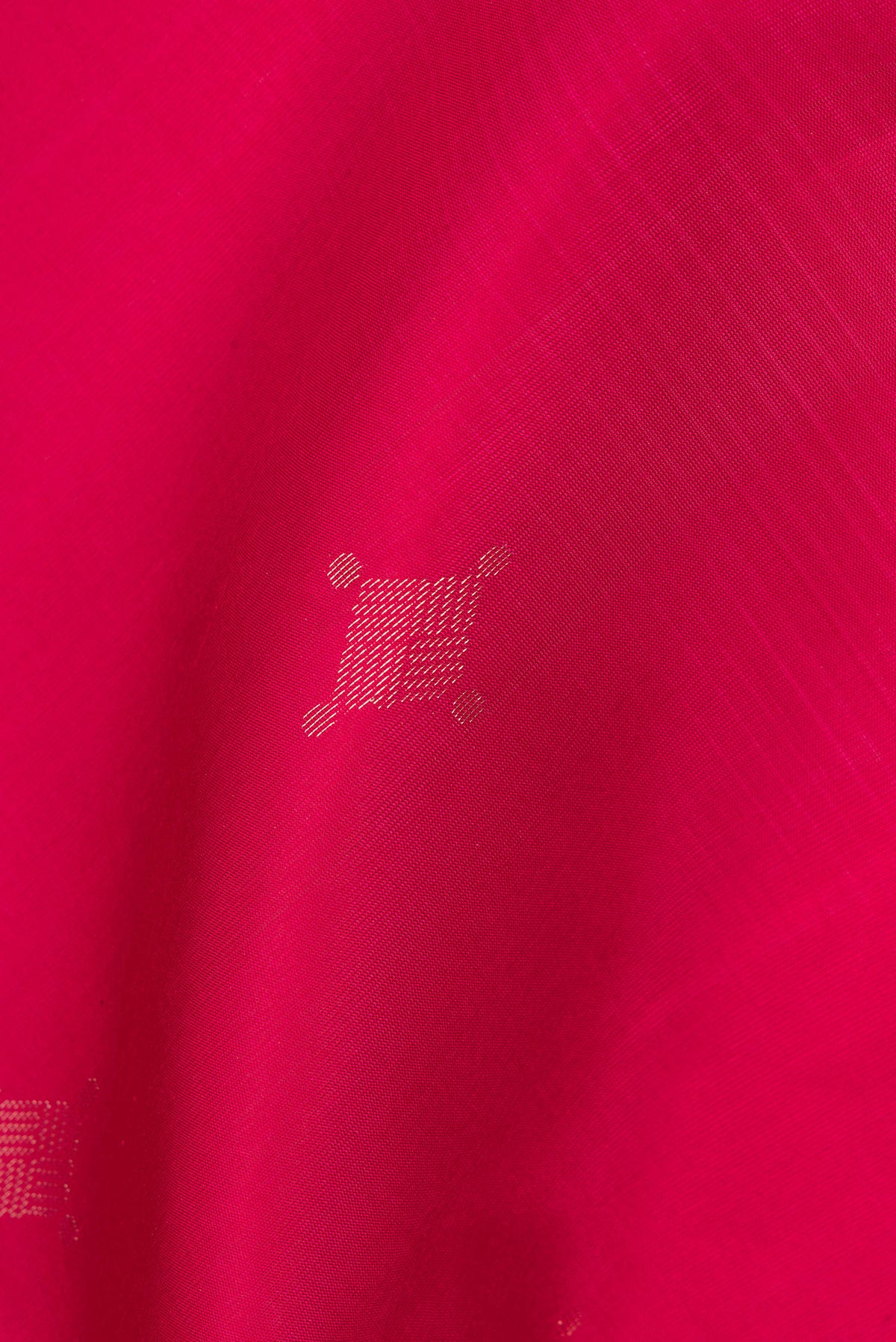 Close up of Pure Silk Dark Pink Soft Saree with Zari Butta on the body and Without Border.  displaying folds