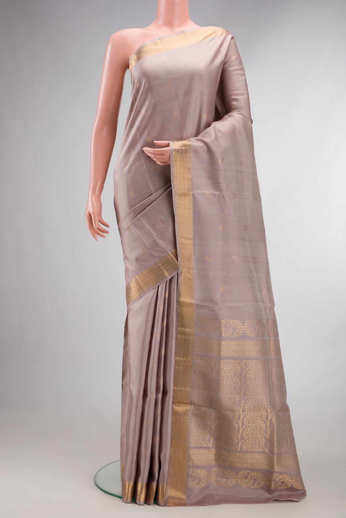 Pure Silk Rose Gold Soft Saree with Zari Butta on the body and Zari Border.  displayed on a mannequin