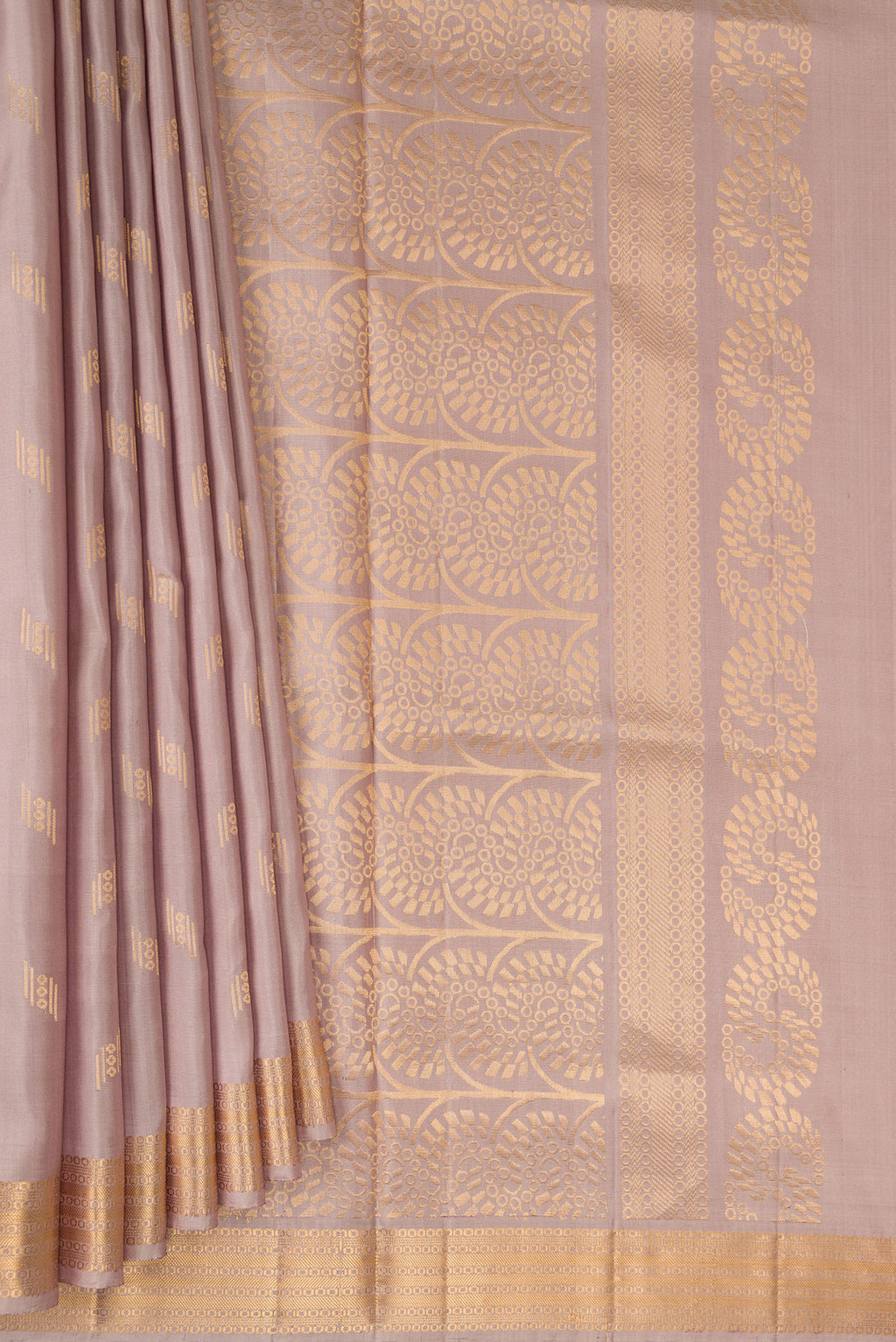 Pleats and pallu of Pure Silk Rose Gold Soft Saree with Zari Butta on the body and Zari Border. 