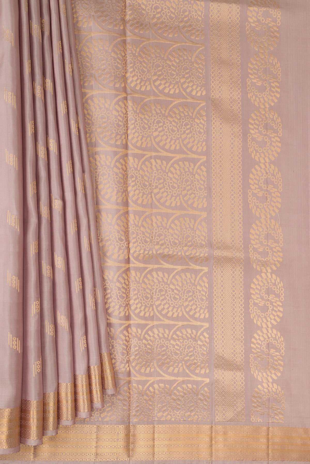 Pleats and pallu of Pure Silk Rose Gold Soft Saree with Zari Butta on the body and Zari Border. 