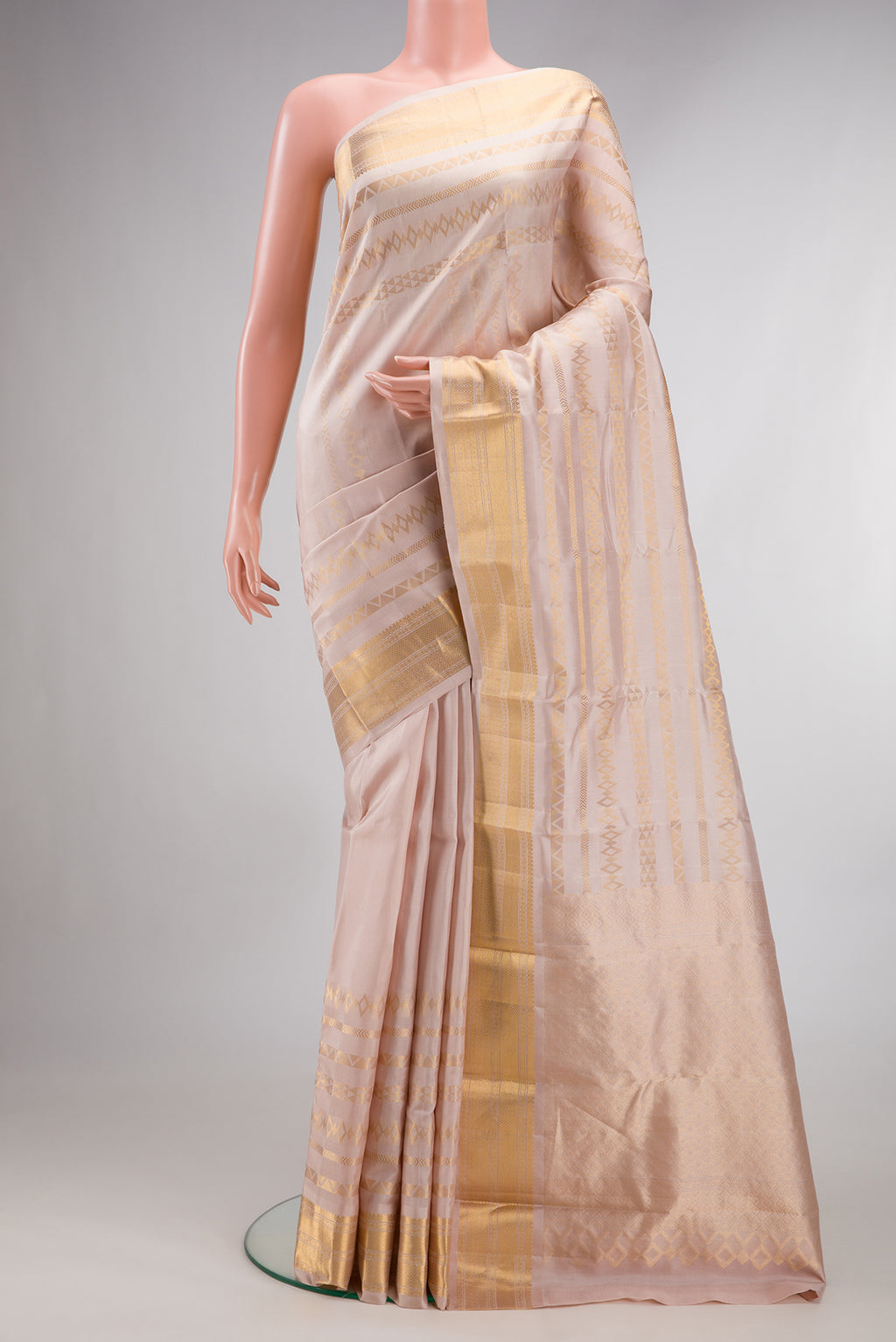 Pure Silk Rose Gold Dual Tone Kanchipuram Saree with Stripes on the body and Zari Border.  displayed on a mannequin