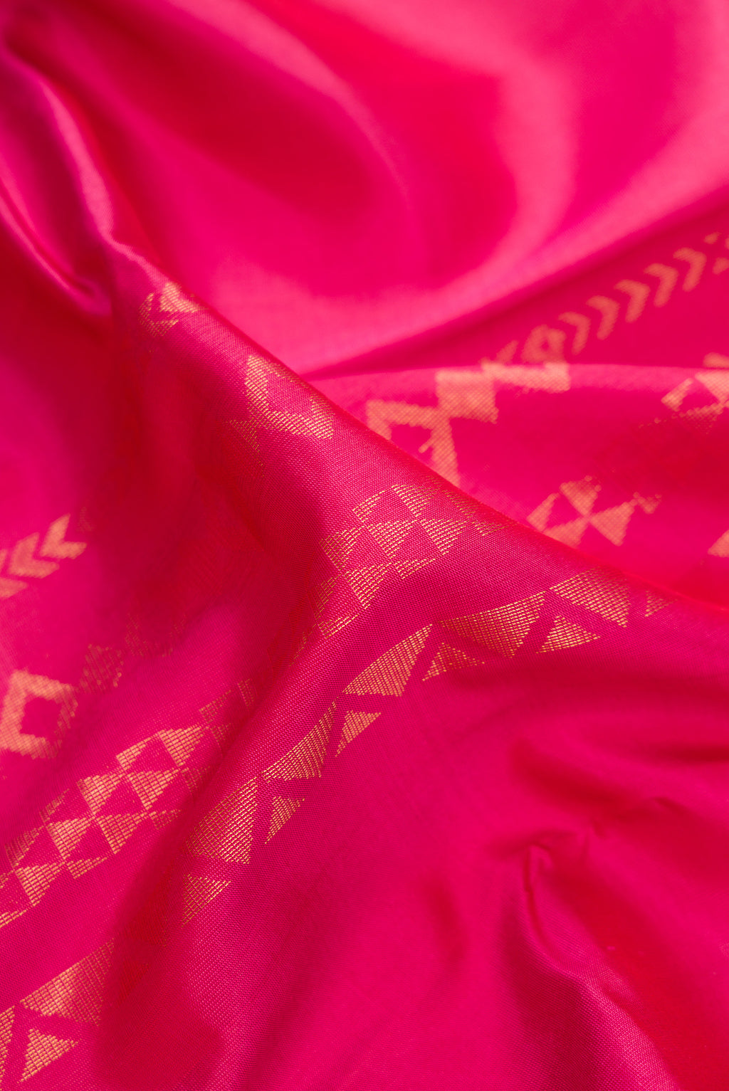 Close up of Pure Silk Dark Pink Kanchipuram Saree with Stripes on the body and Zari Border.  displaying folds