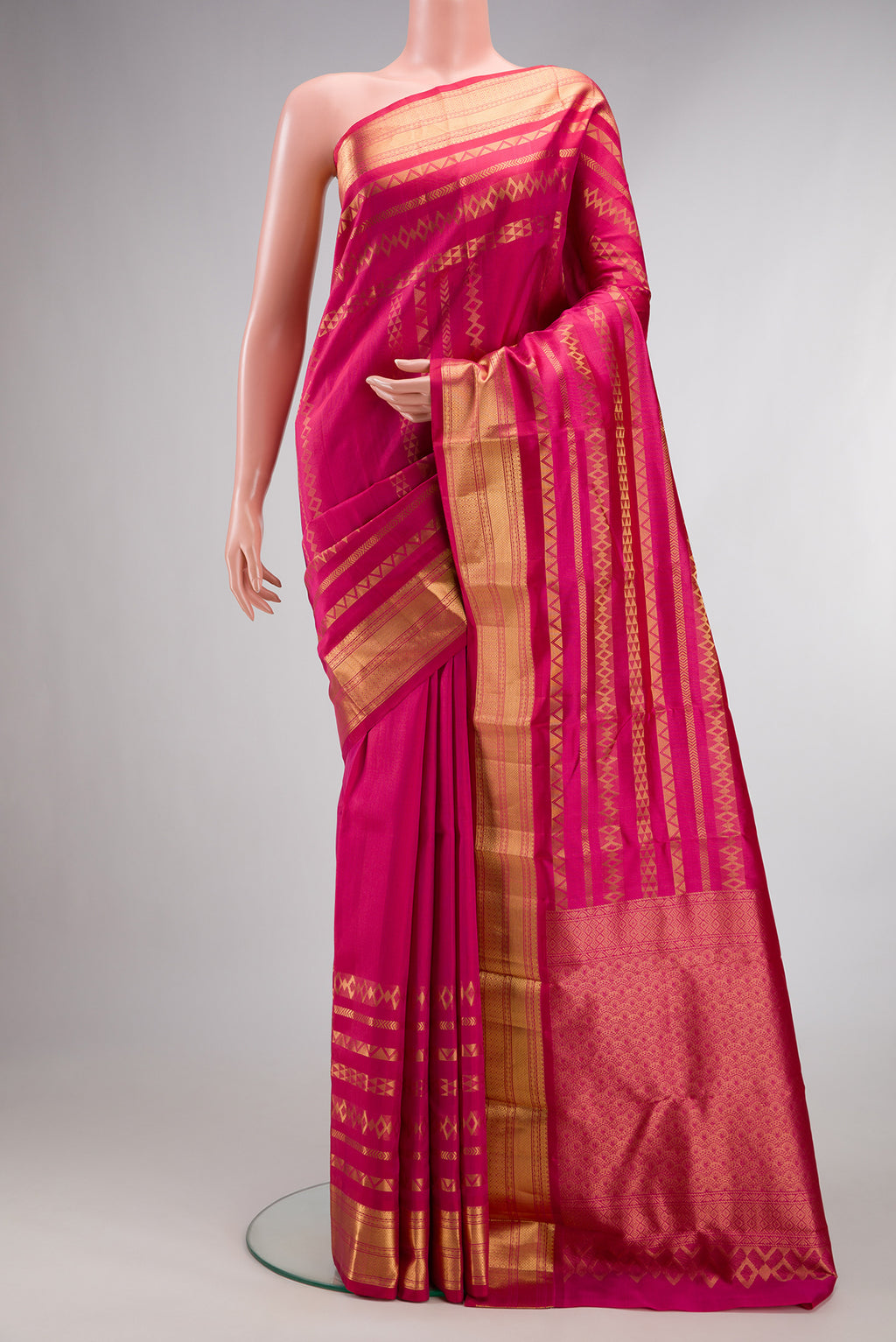 Pure Silk Dark Pink Kanchipuram Saree with Stripes on the body and Zari Border.  displayed on a mannequin
