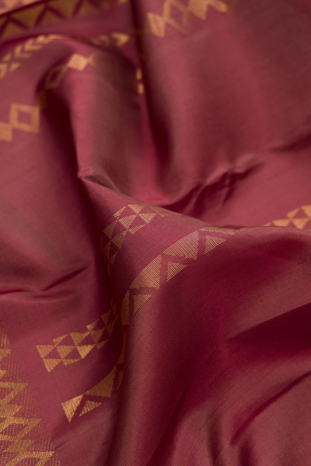 Close up of Pure Silk Brown Kanchipuram Saree with Stripes on the body and Zari Border.  displaying folds