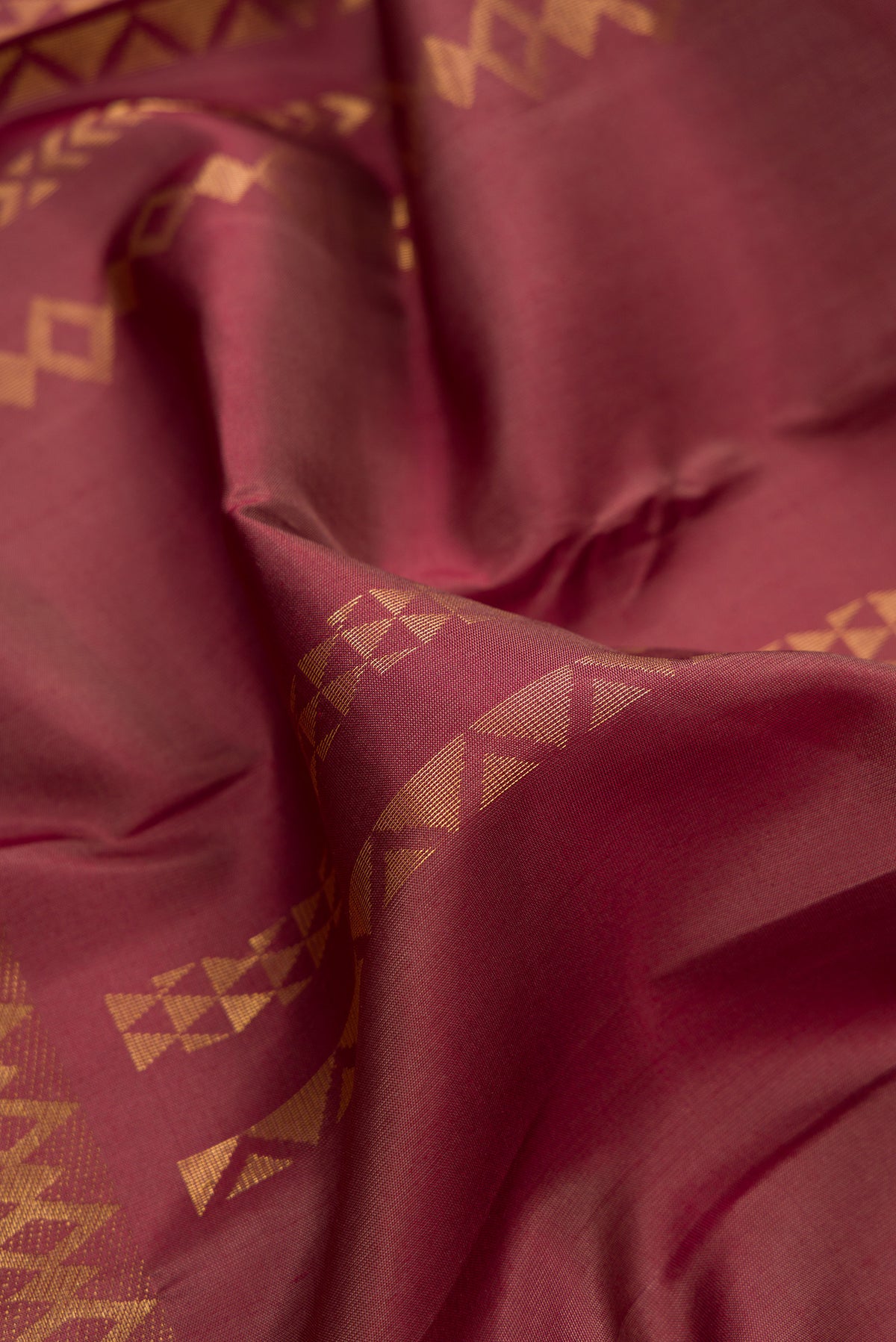 Close up of Pure Silk Brown Kanchipuram Saree with Stripes on the body and Zari Border.  displaying folds