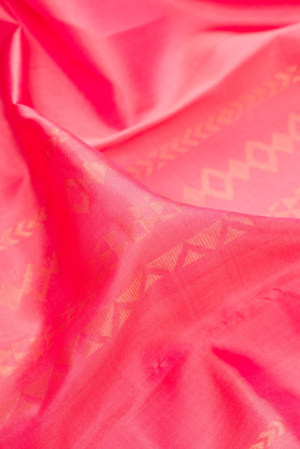 Close up of Pure Silk Coral Kanchipuram Saree with Stripes on the body and Zari Border.  displaying folds