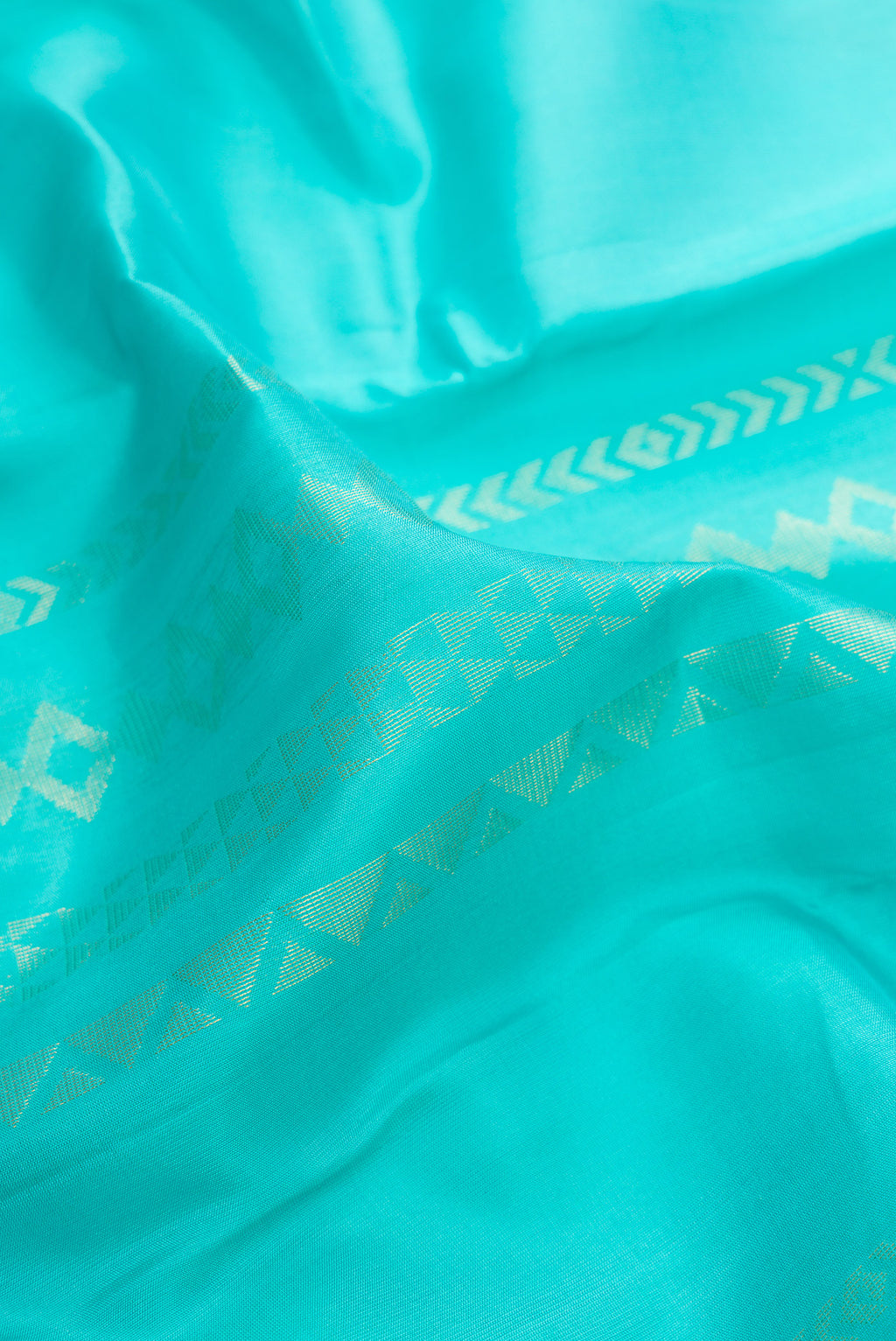 Close up of Pure Silk Turquoise Kanchipuram Saree with Stripes on the body and Zari Border.  displaying folds