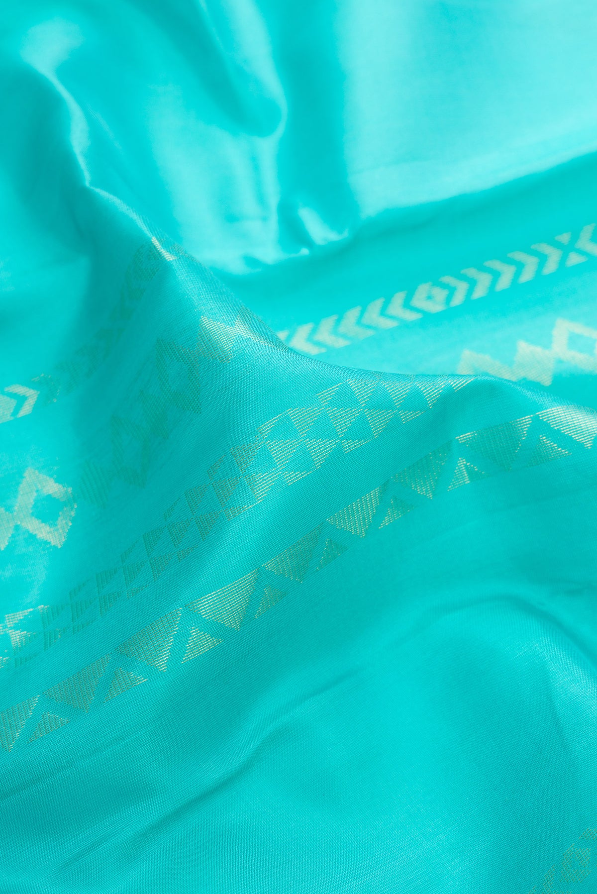 Close up of Pure Silk Turquoise Kanchipuram Saree with Stripes on the body and Zari Border.  displaying folds
