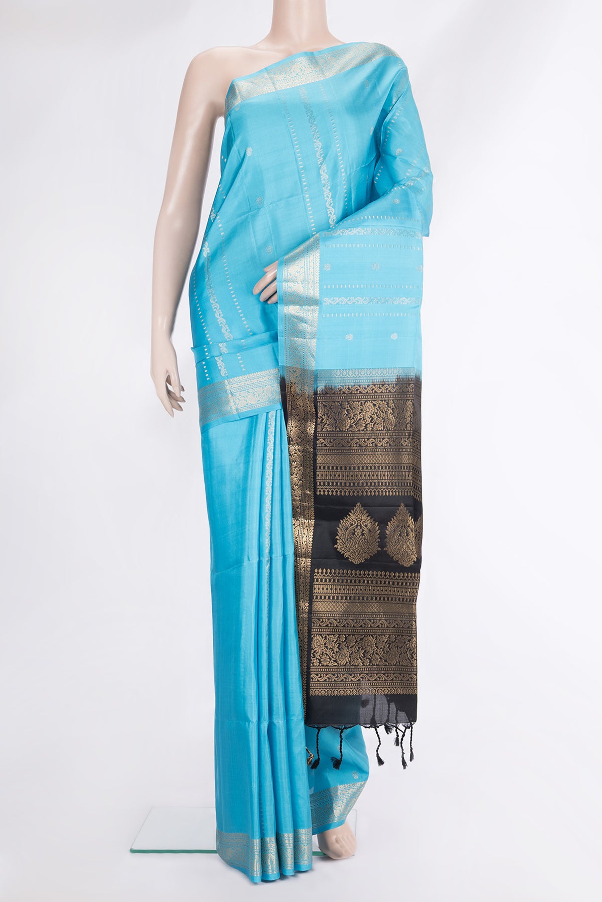 Pure Silk Sky Blue Soft Saree with Zari Butta on the body and Zari Border.  displayed on a mannequin