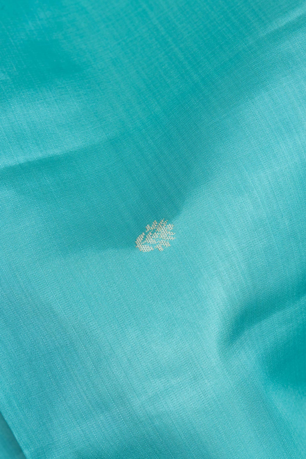 Close up of Pure Silk Sky Blue Soft Saree with Zari Butta on the body and Zari Border.  displaying folds