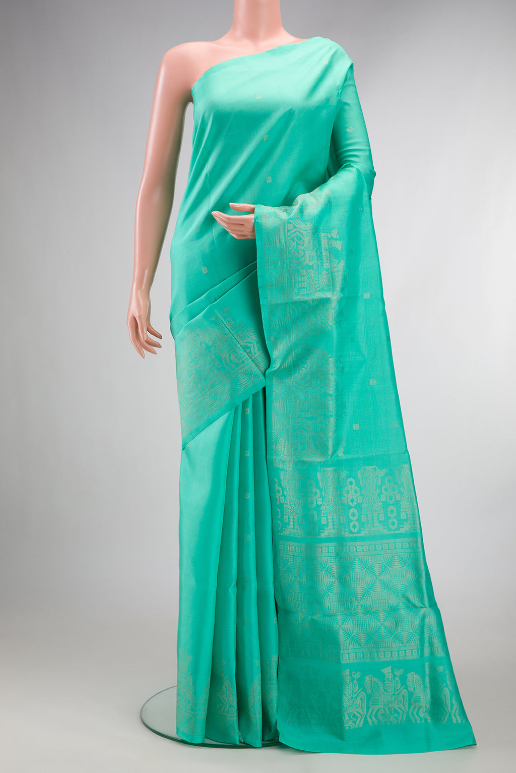 Pure Silk Sea Green Soft Saree with Zari Butta on the body and Fancy Border.  displayed on a mannequin