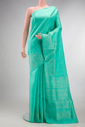 Pure Silk Sea Green Soft Saree with Zari Butta on the body and Fancy Border.  displayed on a mannequin