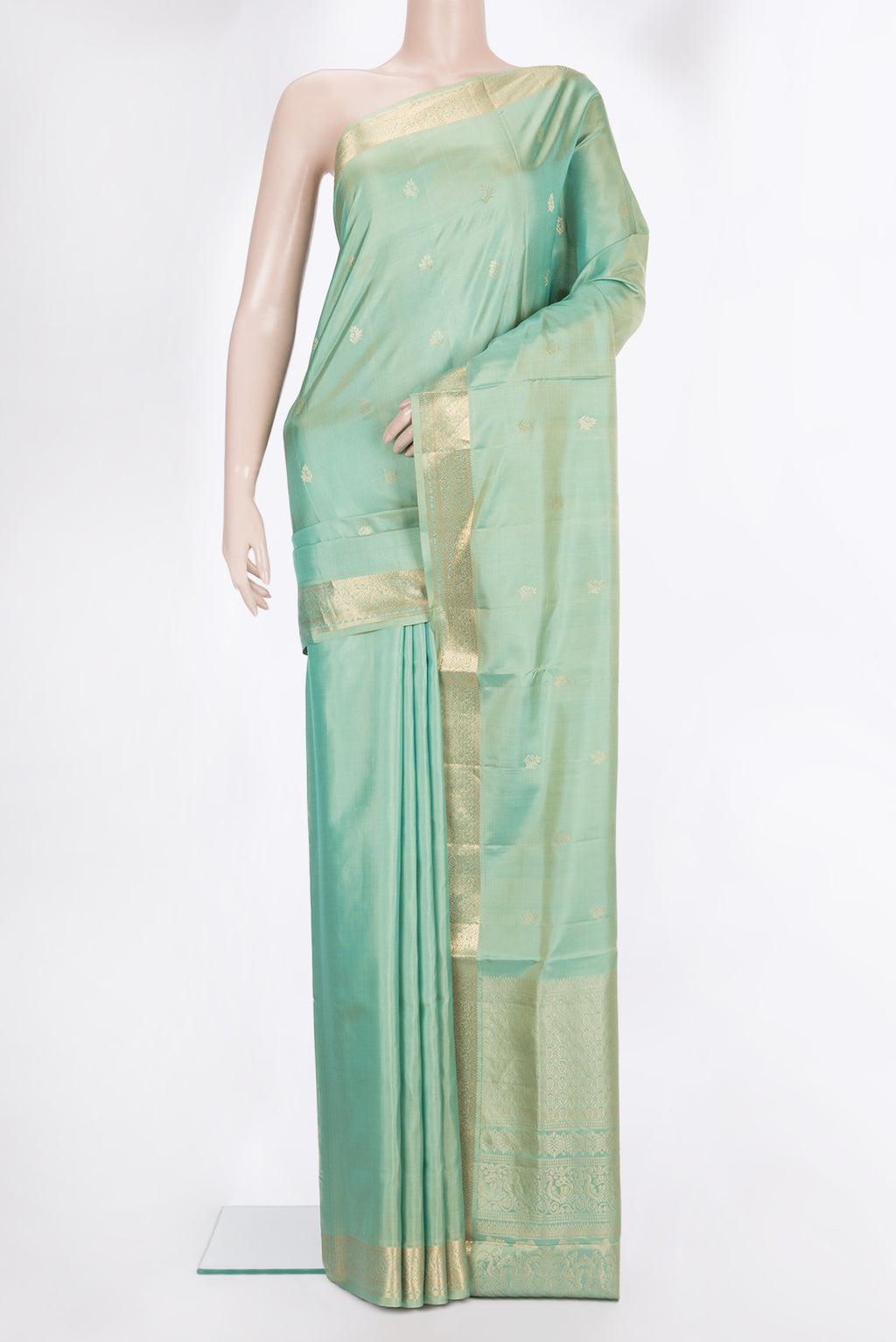 Pure Silk Pista Green Soft Saree with Zari Butta on the body and Zari Border.  displayed on a mannequin