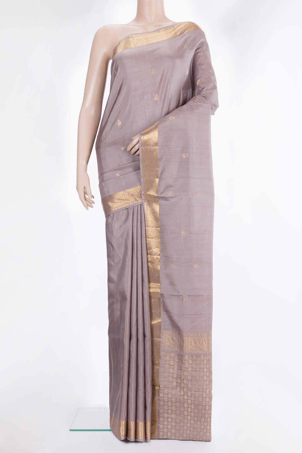 Pure Silk Beige Soft Saree with Zari Butta on the body and Zari Border.  displayed on a mannequin