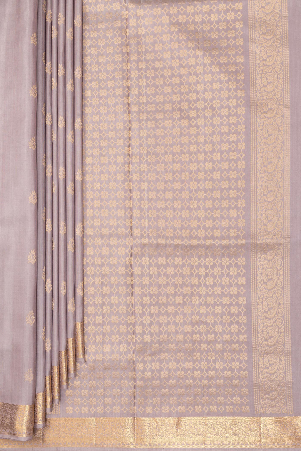 Pleats and pallu of Pure Silk Beige Soft Saree with Zari Butta on the body and Zari Border. 