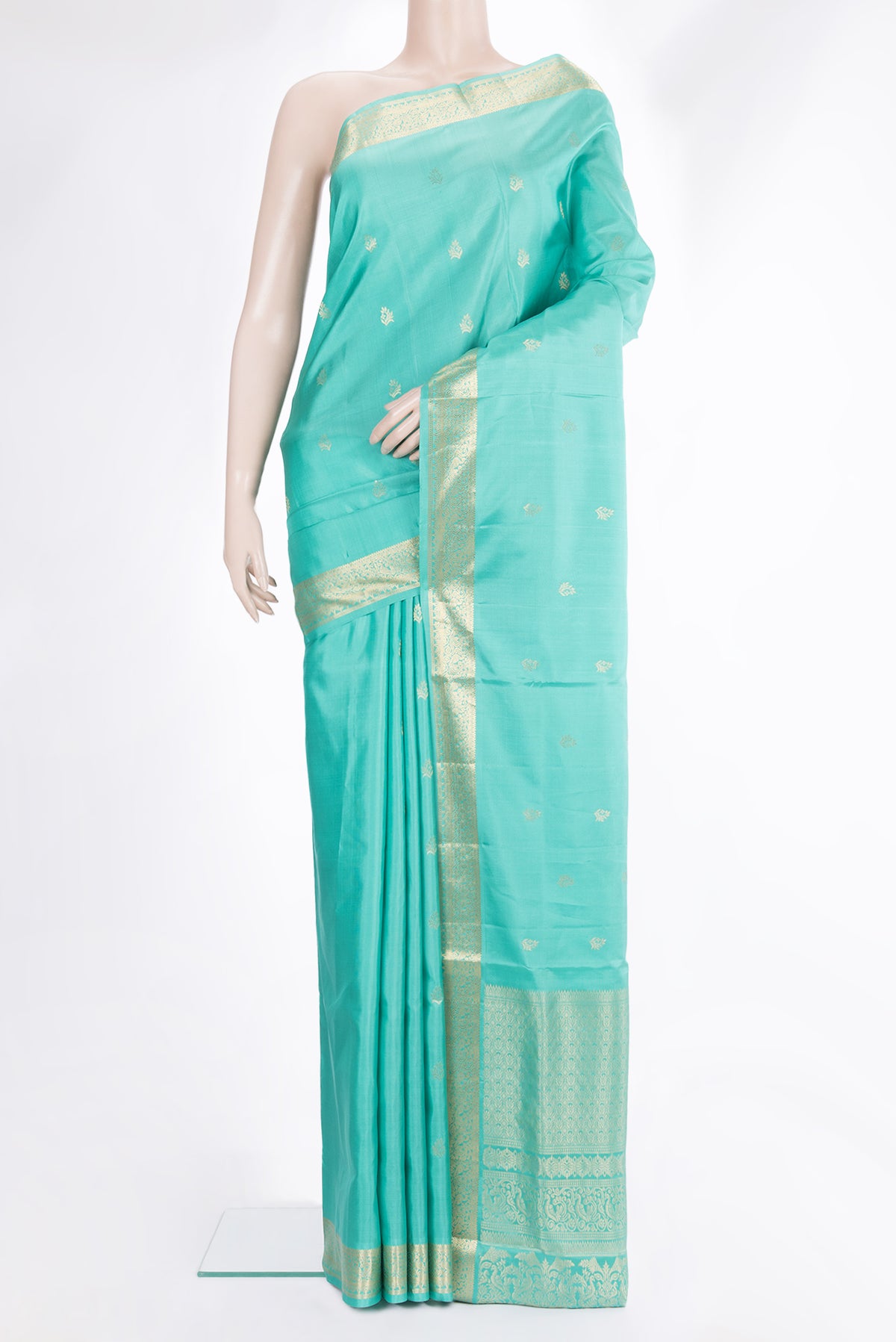 Pure Silk Sea Green Soft Saree with Zari Butta on the body and Zari Border.  displayed on a mannequin
