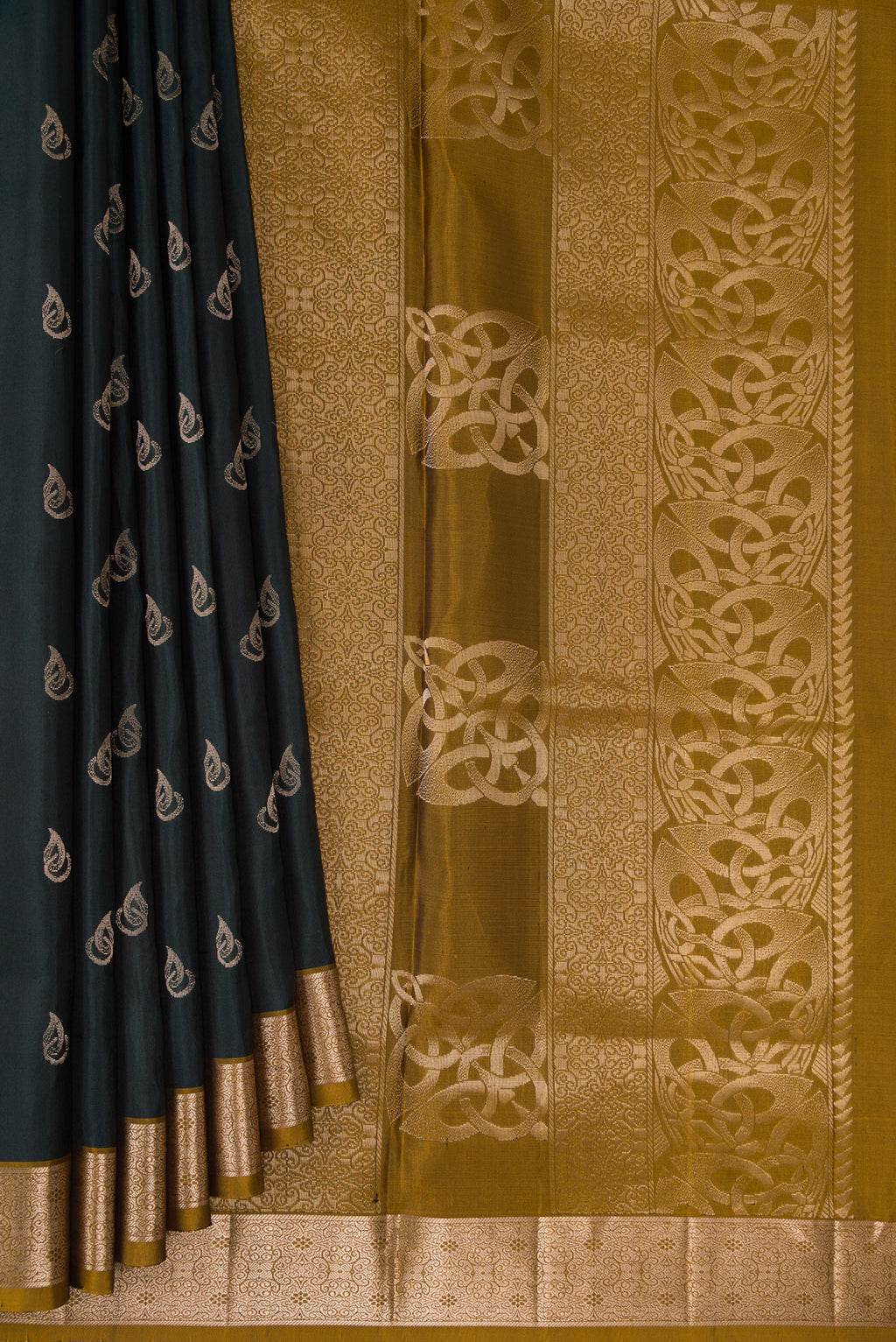 Pleats and pallu of Pure Silk Bottle Green Soft Saree with Zari Butta on the body and Zari Border. 