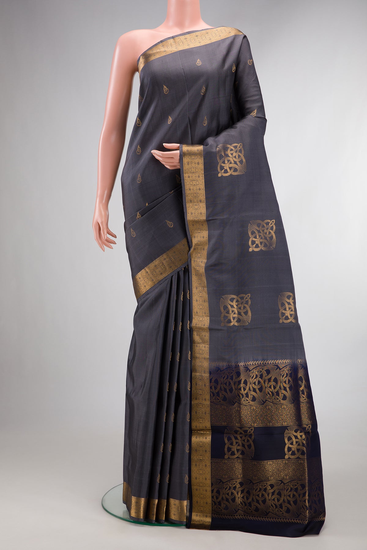 Pure Silk Grey Soft Saree with Zari Butta on the body and Zari Border.  displayed on a mannequin