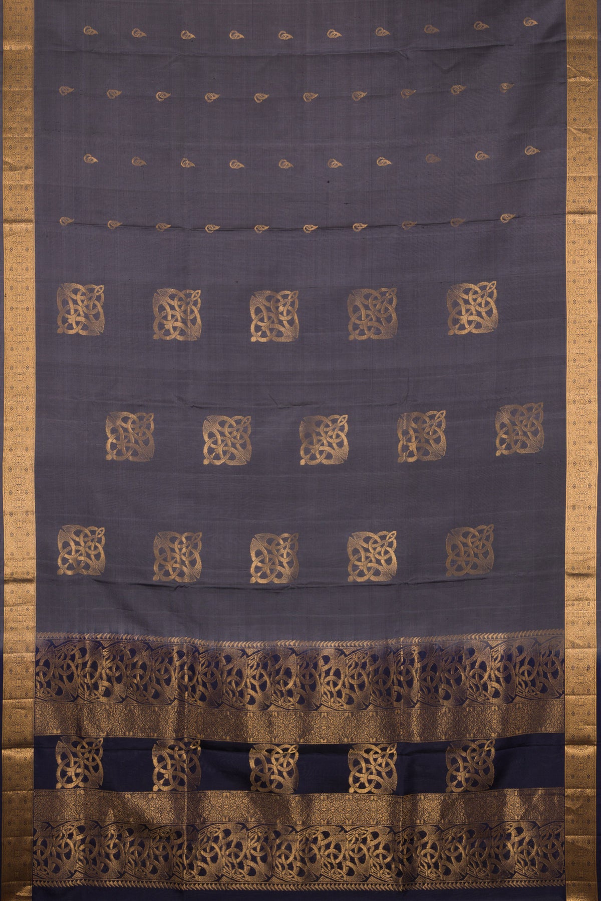 Flat view of Pure Silk Grey Soft Saree with Zari Butta on the body and Zari Border. 