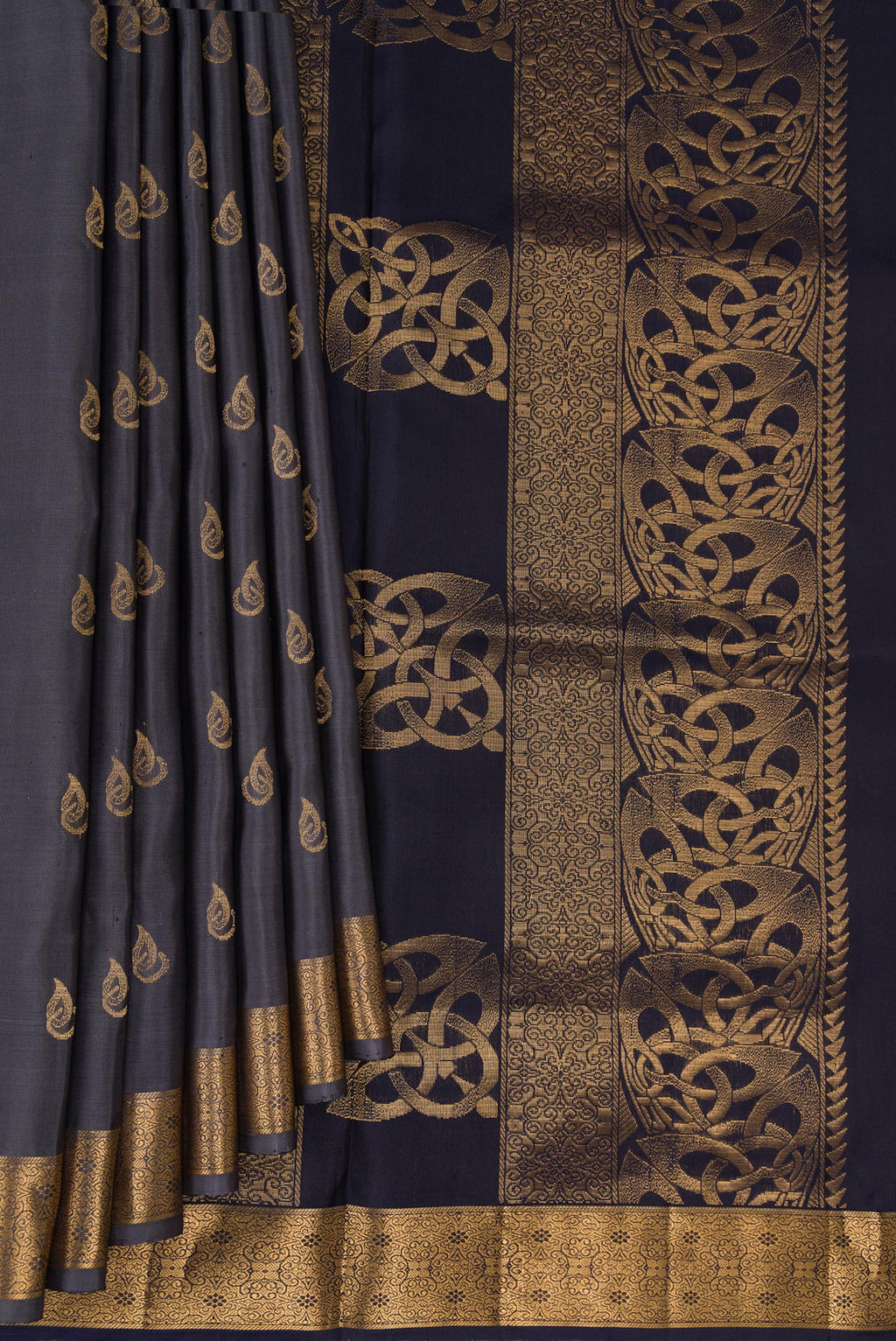 Pleats and pallu of Pure Silk Grey Soft Saree with Zari Butta on the body and Zari Border. 