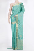 Pure Silk Light Green Soft Saree with Zari Butta on the body and Zari Border.  displayed on a mannequin
