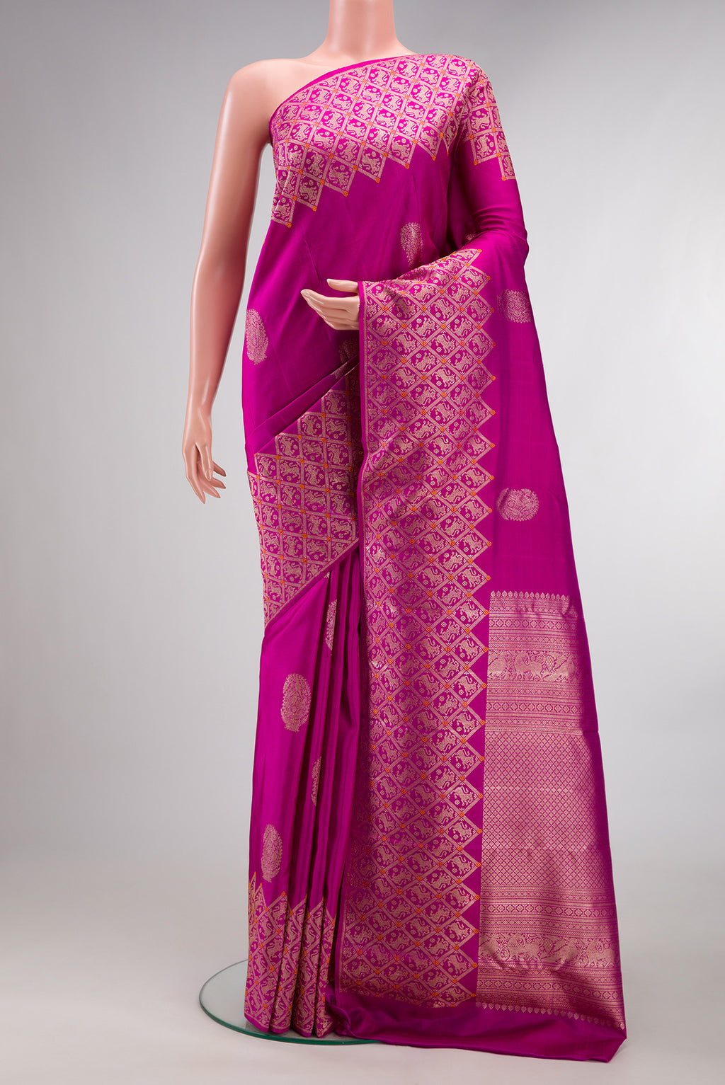 Pure Silk Pink Kanjivaram Saree with Zari Butta on the body and Fancy Border.  displayed on a mannequin