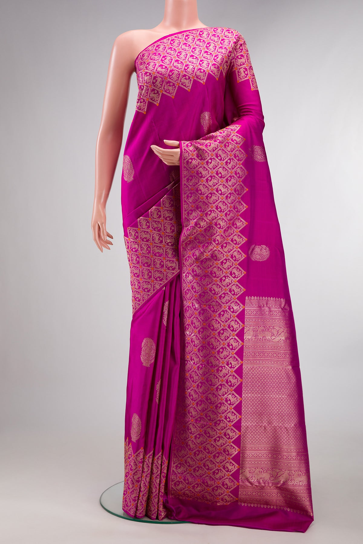 Pure Silk Pink Kanjivaram Saree with Zari Butta on the body and Fancy Border.  displayed on a mannequin