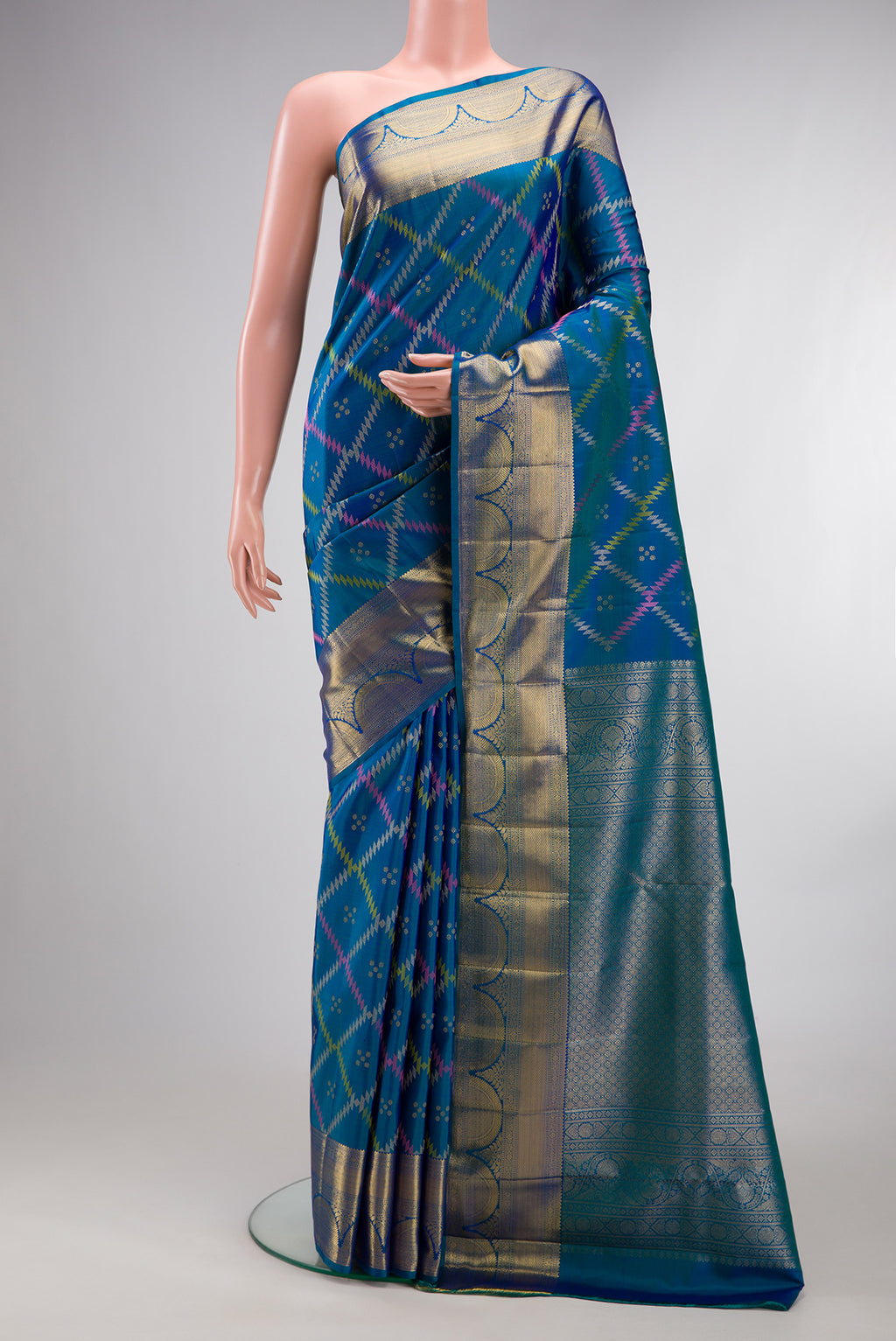 Pure Silk Peacock Blue Dual Tone Kanjivaram Saree with Zari Butta on the body and Zari Border.  displayed on a mannequin