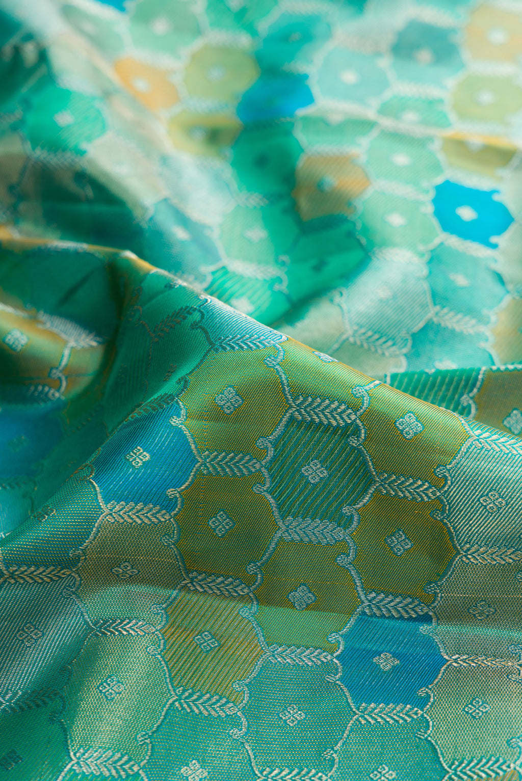 Close up of Pure Silk Sea Green Dual Tone Kanjivaram Saree with Zari Brocade on the body and Zari Border.  displaying folds