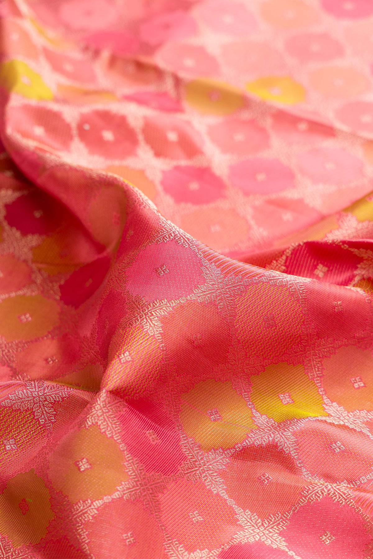 Close up of Pure Silk Coral Kanjivaram Saree with Zari Brocade on the body and Zari Border.  displaying folds