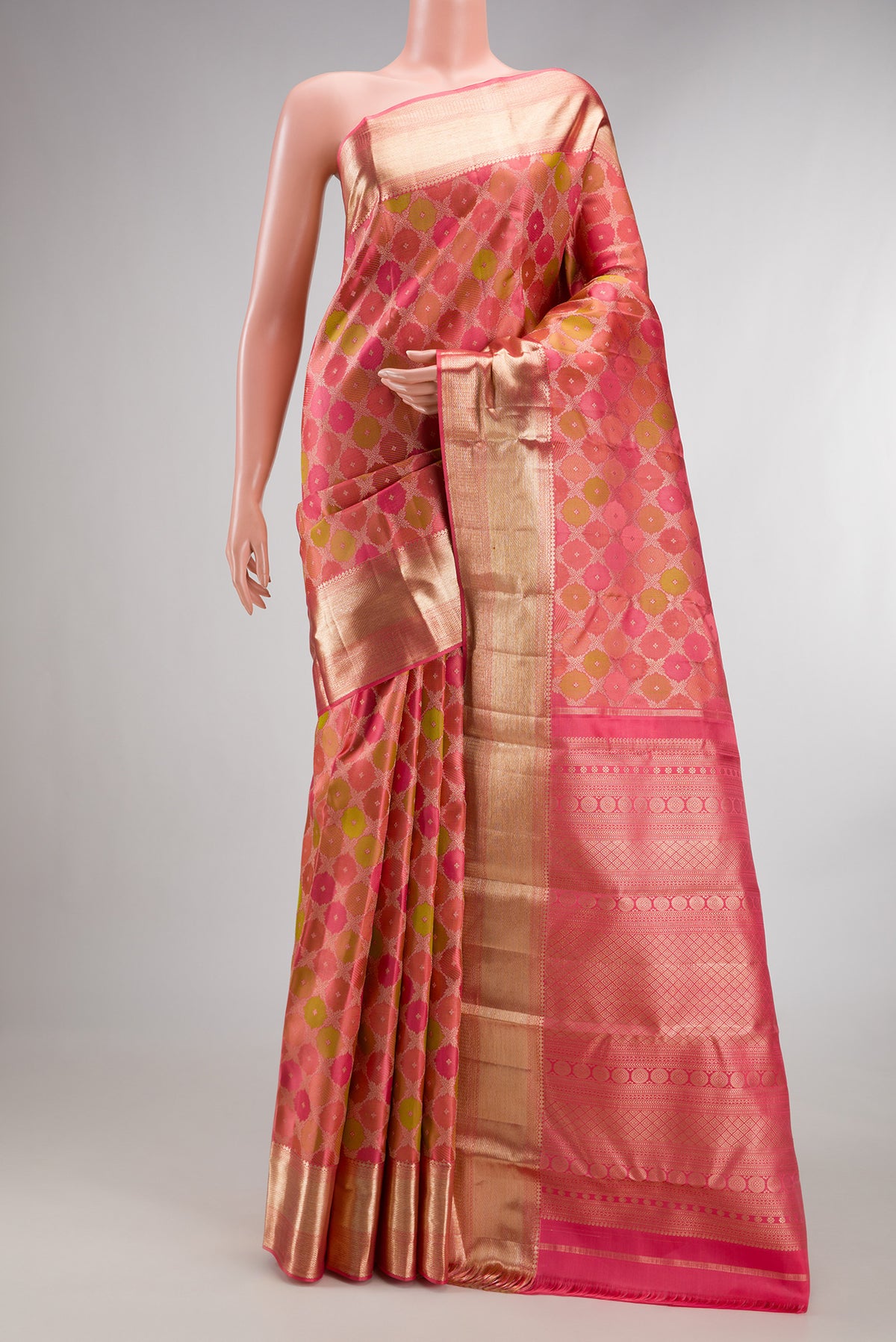 Pure Silk Coral Kanjivaram Saree with Zari Brocade on the body and Zari Border.  displayed on a mannequin