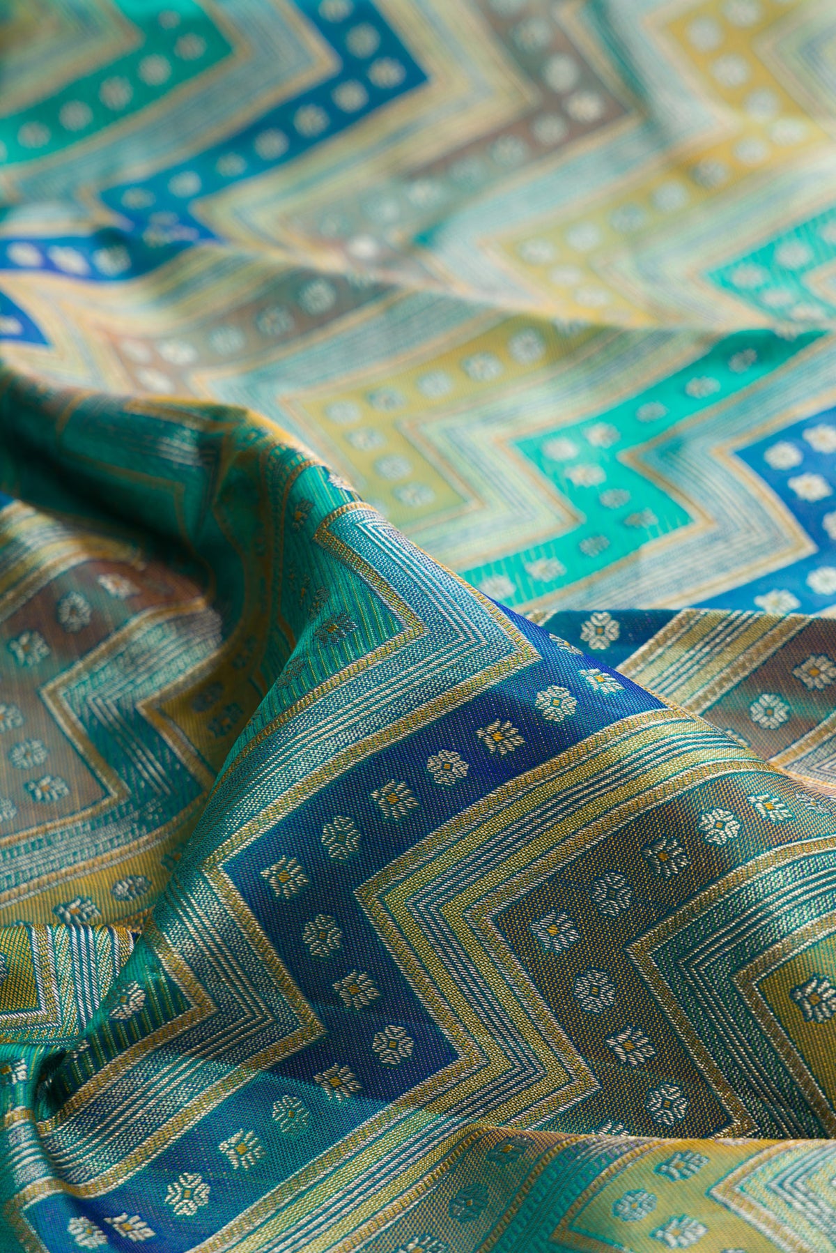 Close up of Pure Silk Turquoise Dual Tone Kanjivaram Saree with Zari Brocade on the body and Zari Border.  displaying folds