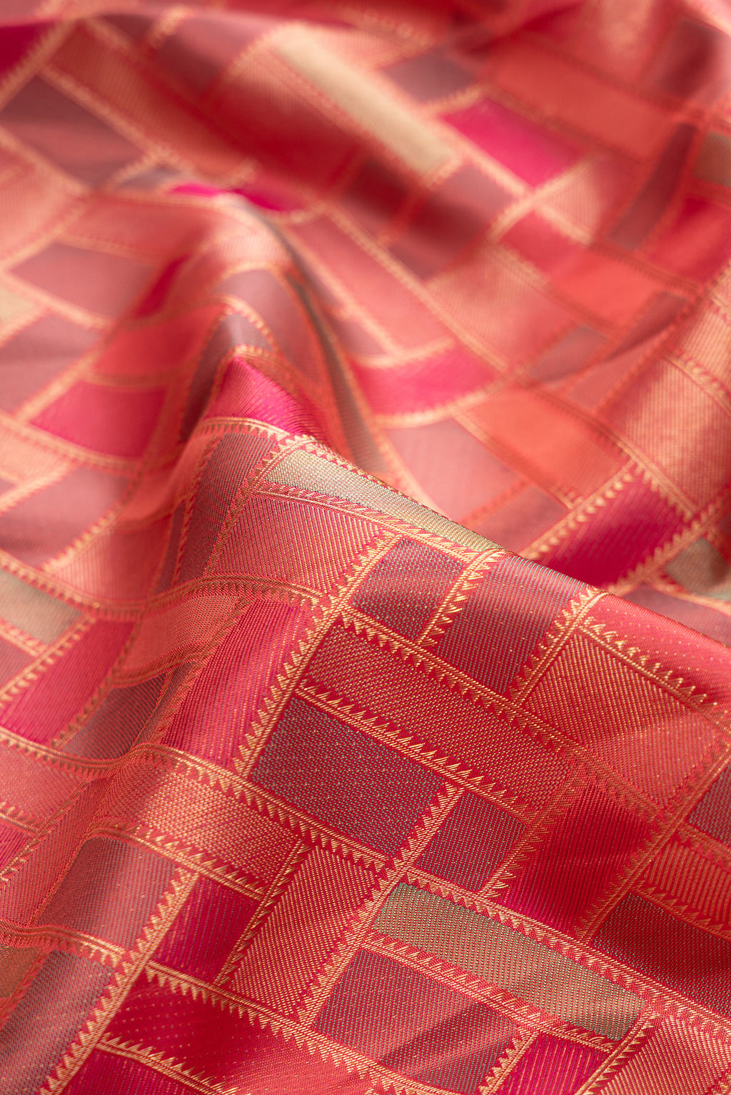 Close up of Pure Silk Pink Kanjivaram Saree with Zari Brocade on the body and Zari Border.  displaying folds