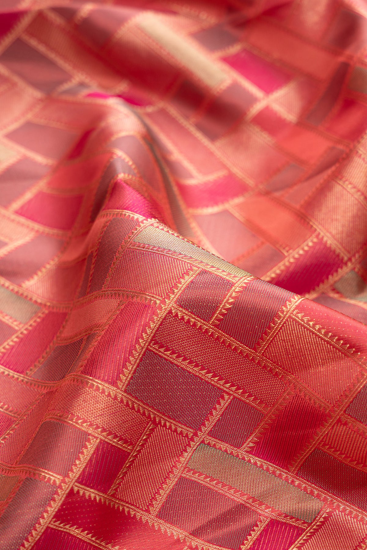 Close up of Pure Silk Pink Kanjivaram Saree with Zari Brocade on the body and Zari Border.  displaying folds