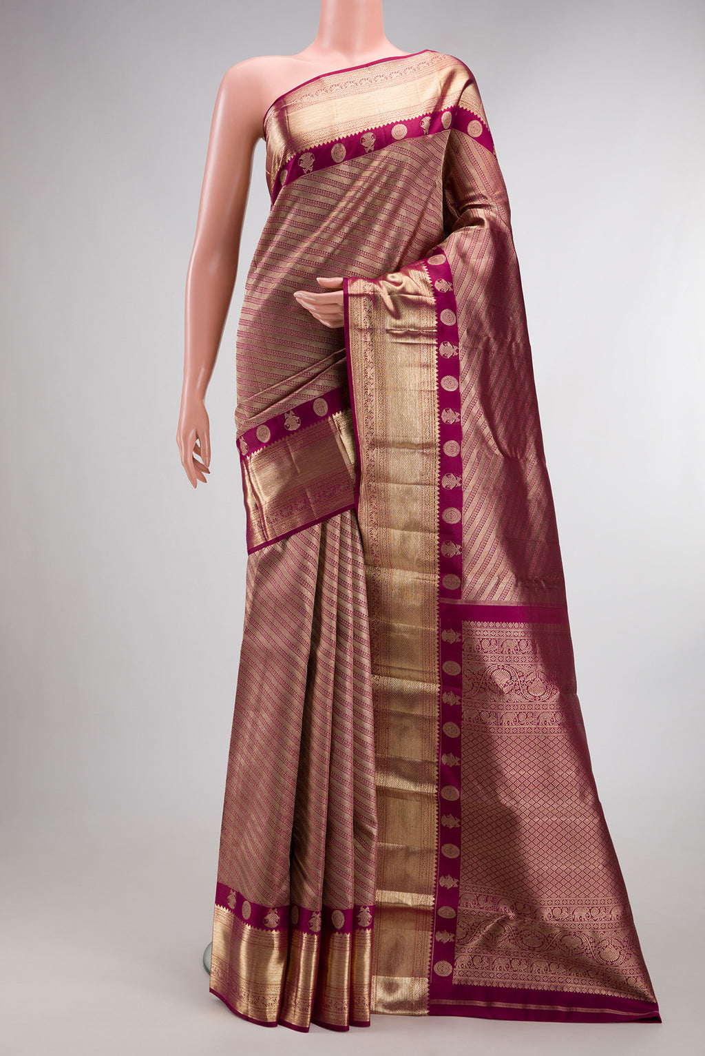 Pure Silk Magenta Kanjivaram Saree with Zari Brocade on the body and Fancy Border.  displayed on a mannequin