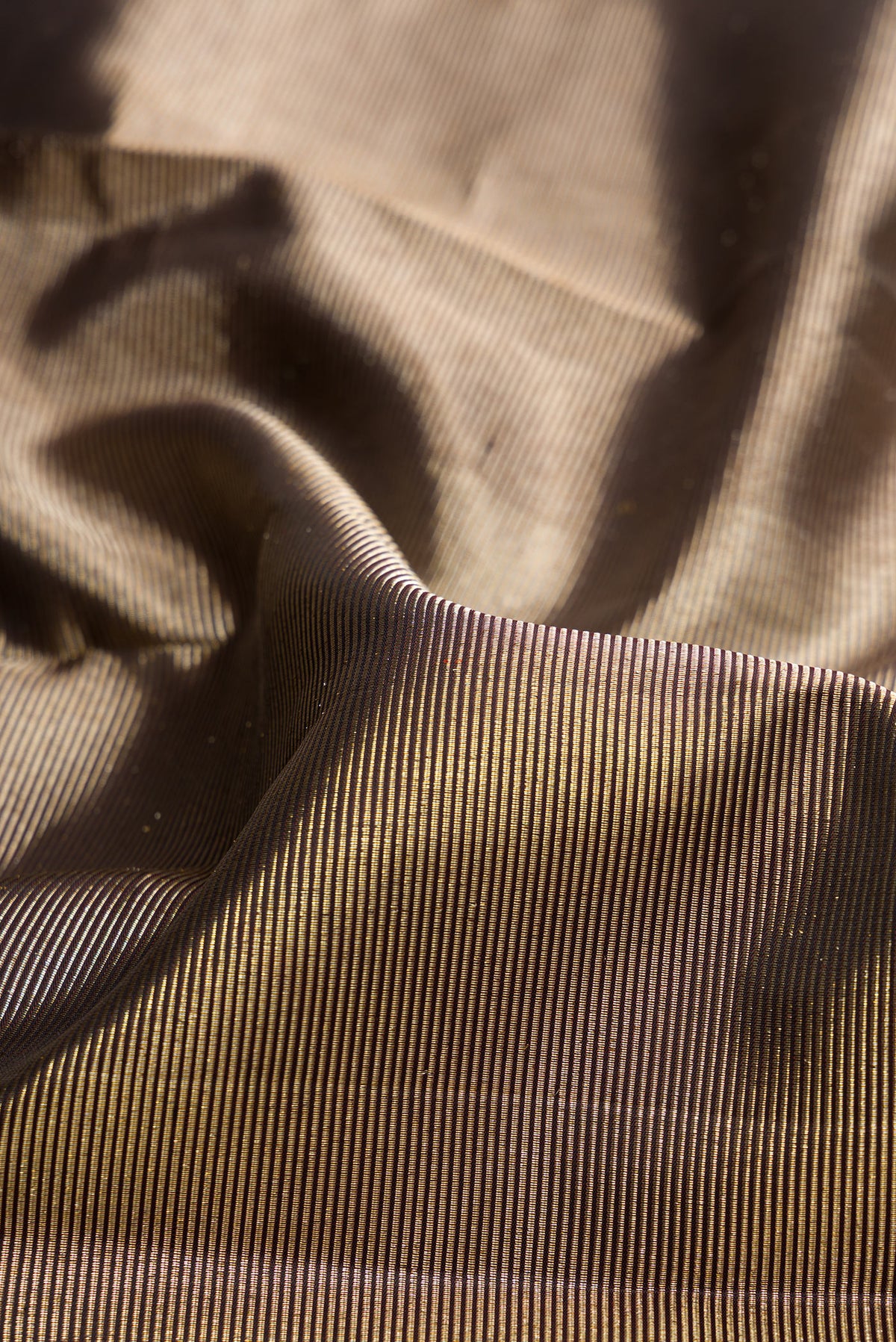 Close up of Pure Silk Coffee Brown Dual Tone Kanjivaram Saree with Zari Brocade on the body and Fancy Border.  displaying folds