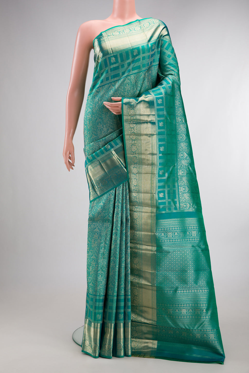Pure Silk Sea Green Dual Tone Kanjivaram Saree with Zari Brocade on the body and Fancy Border.  displayed on a mannequin