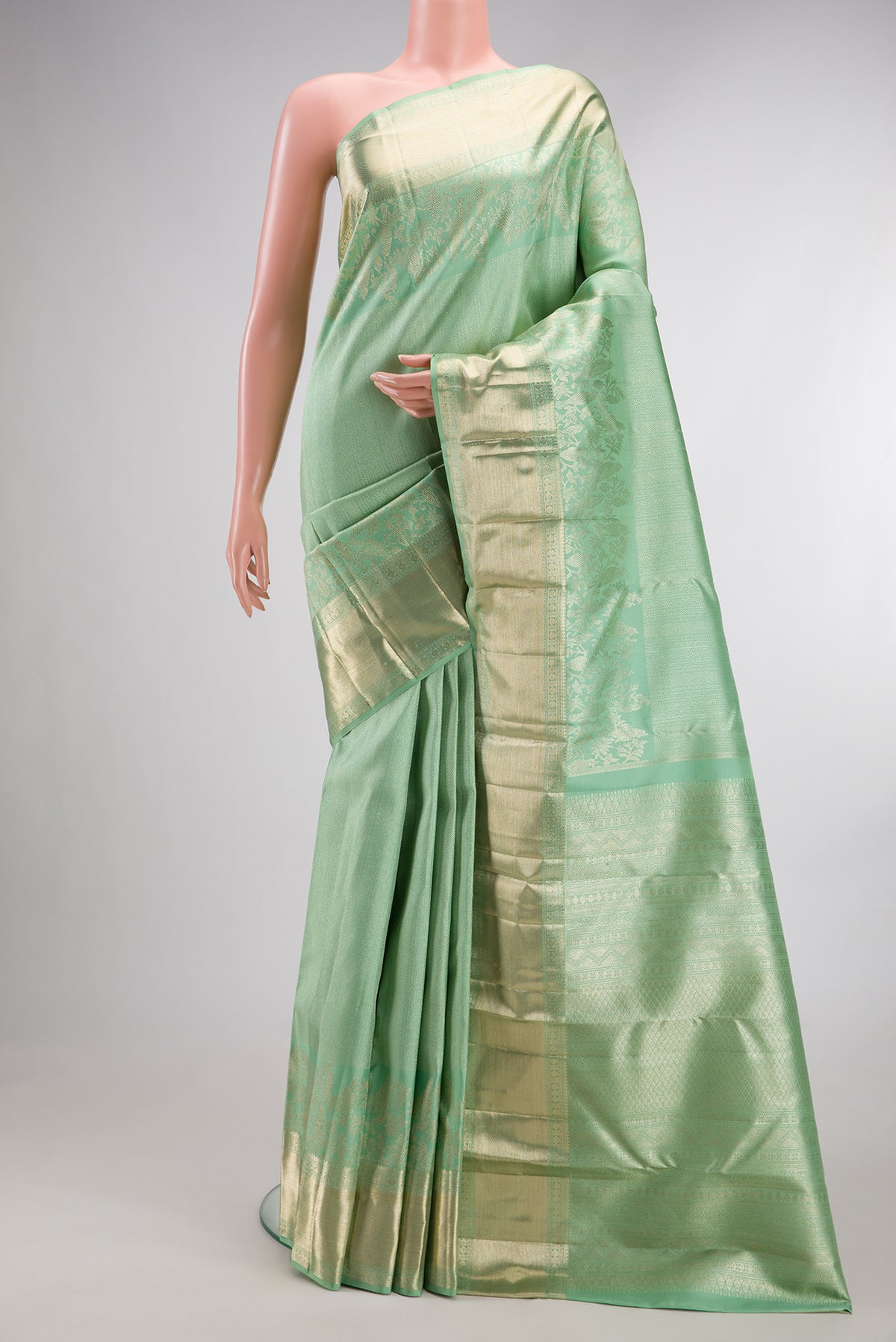 Pure Silk Pista Green Kanjivaram Saree with Zari Brocade on the body and Fancy Border.  displayed on a mannequin
