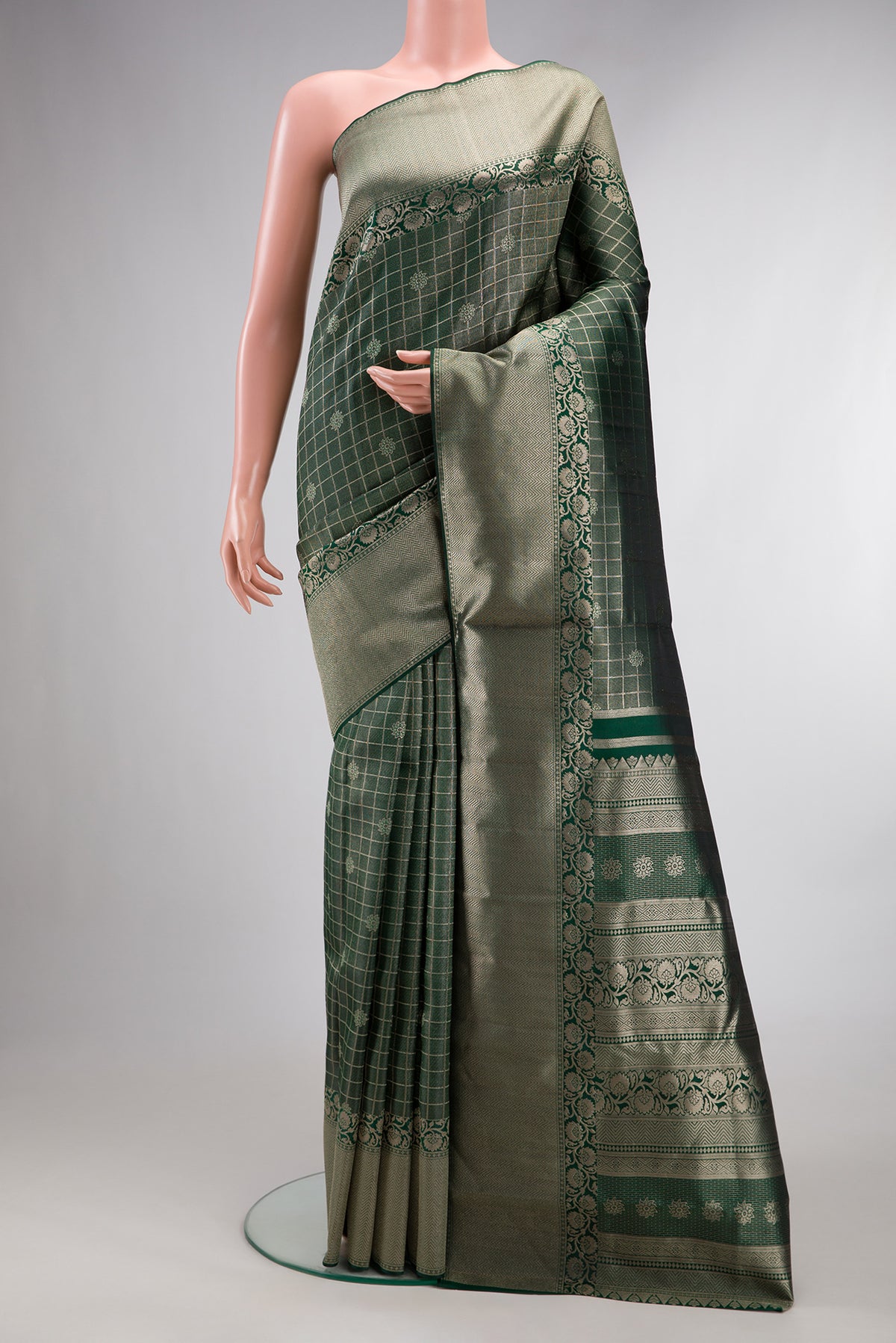 Bottle Green Dual Tone Kanchipuram Tissue Saree with Zari Brocade on the body and Zari Border.  displayed on a mannequin