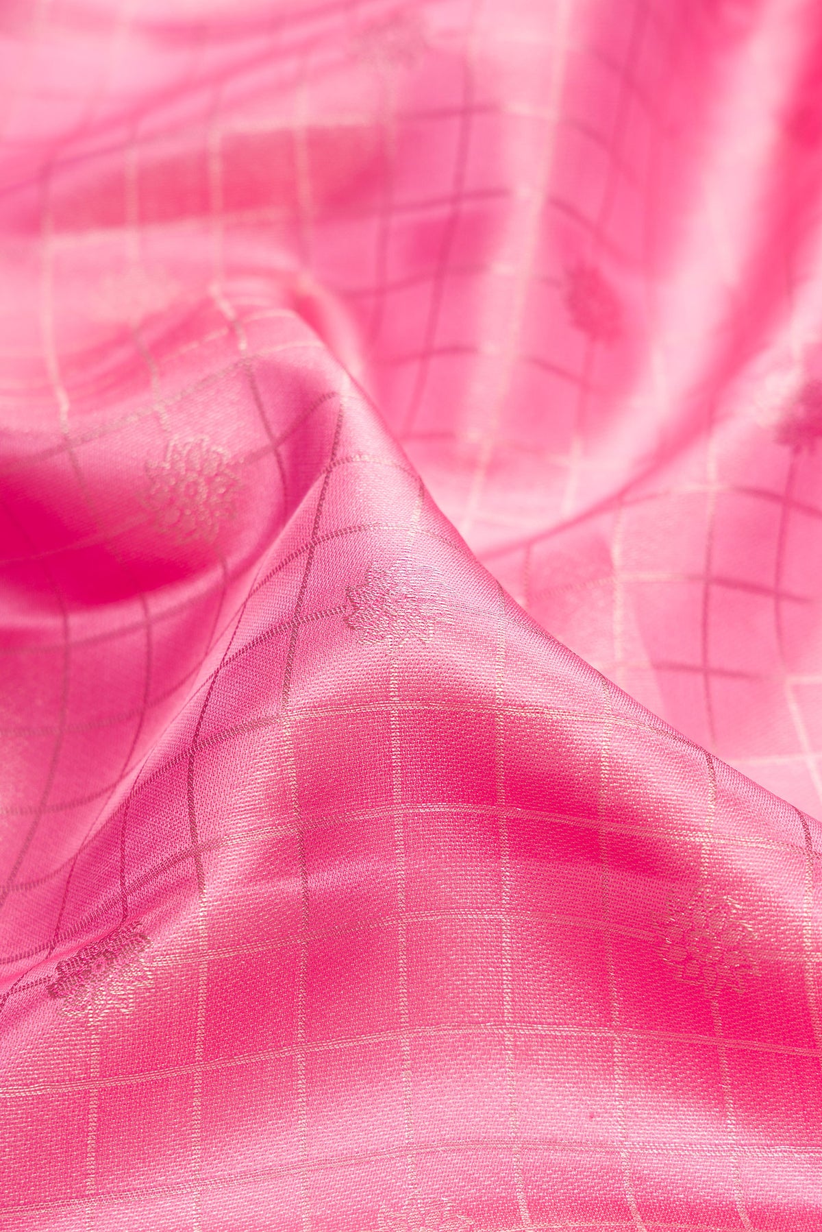 Close up of Pure Silk Pink Kanchipuram Saree with Checked design on the body and Fancy Border.  displaying folds