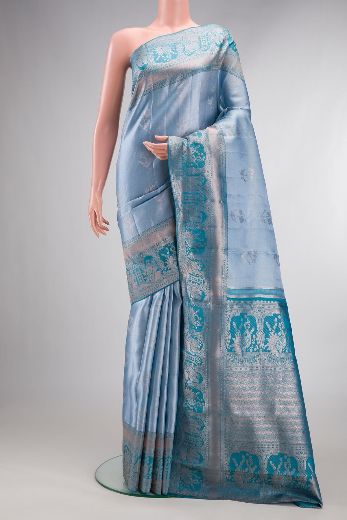 Light Blue Dual Tone Kanchipuram Tissue Saree with Zari Brocade on the body and Fancy Border.  displayed on a mannequin