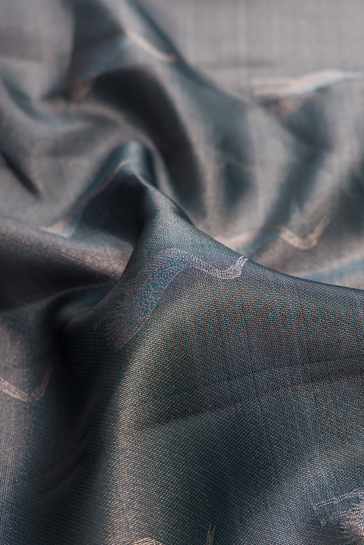 Close up of Grey Dual Tone Kanchipuram Tissue Saree with Zari Brocade on the body and Fancy Border.  displaying folds