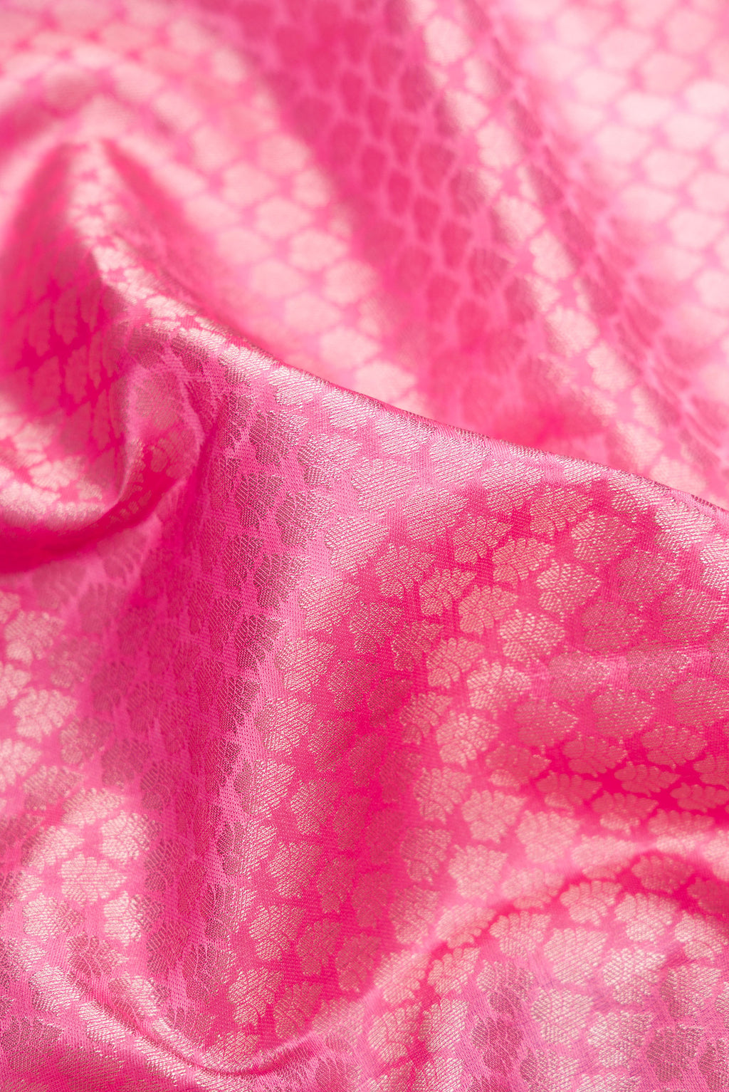 Close up of Rose pink Kanchipuram Tissue Saree with Zari Brocade on the body and Fancy Border.  displaying folds