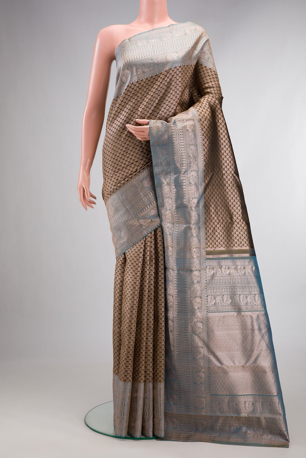 Mehandi Green Dual Tone Kanchipuram Tissue Saree with Zari Brocade on the body and Fancy Border.  displayed on a mannequin