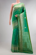 Pure Silk Green Dual Tone Kanjivaram Saree with Zari Butta on the body and Fancy Border.  displayed on a mannequin