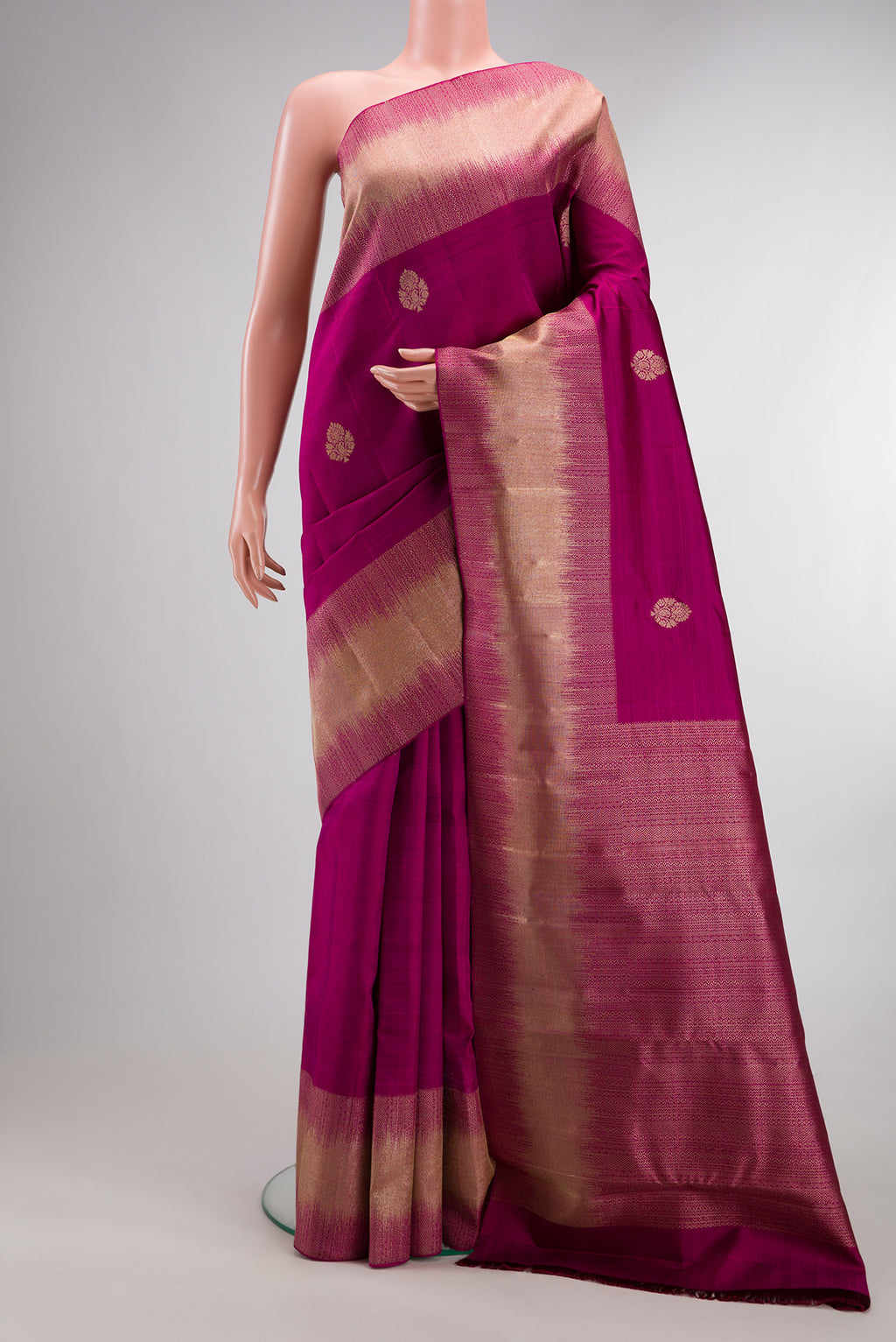Pure Silk Magenta Dual Tone Kanjivaram Saree with Zari Butta on the body and Fancy Border.  displayed on a mannequin